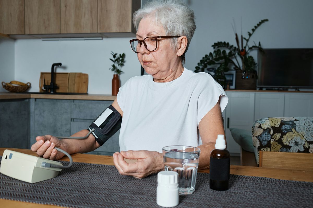 Elderly woman checking her blood pressure