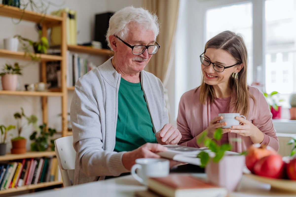 Young woman helping elderly man