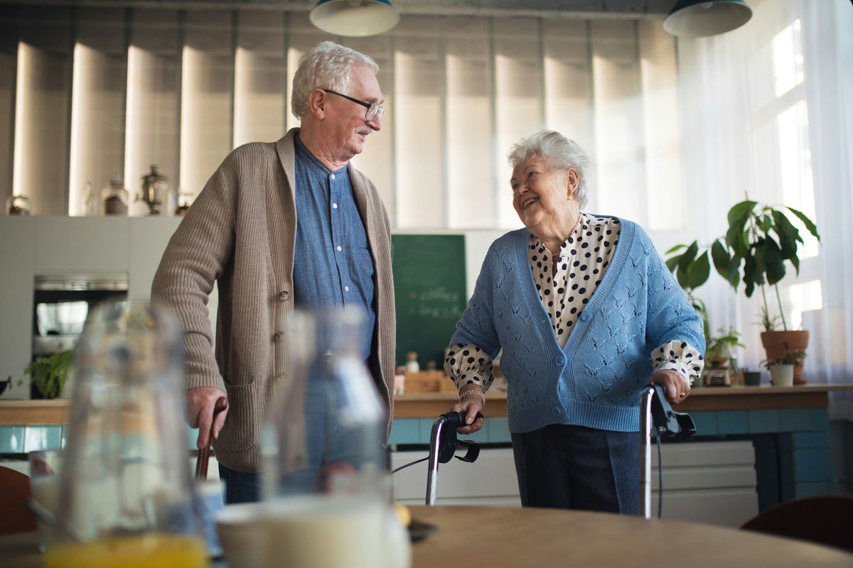 elderly man talking with elderly woman